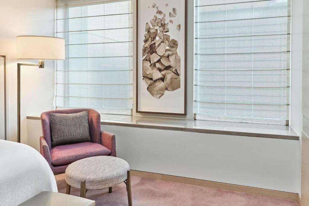 a living room with a chair and a window at The St. Regis San Francisco in San Francisco