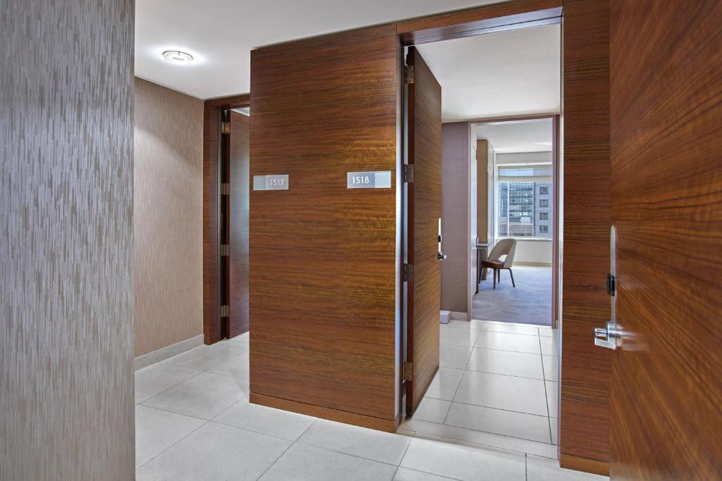 a hallway with a wooden door and a room at The St. Regis San Francisco in San Francisco