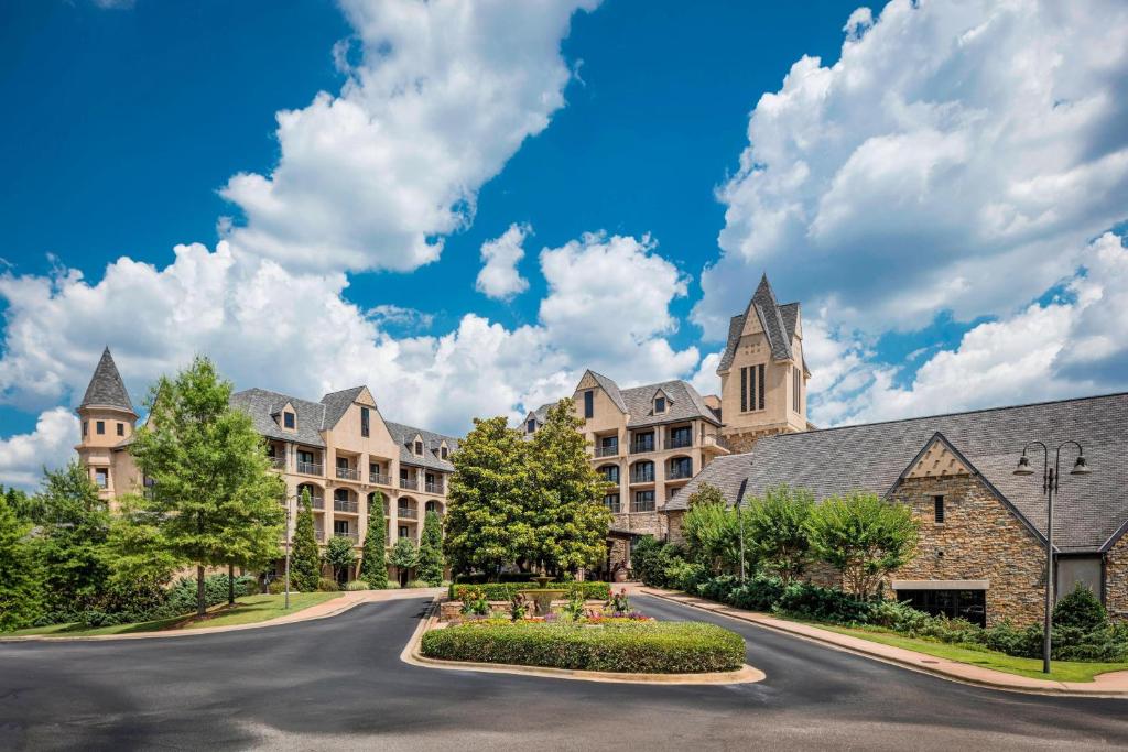 a road in front of a large building at Renaissance Birmingham Ross Bridge Golf Resort & Spa in Hoover