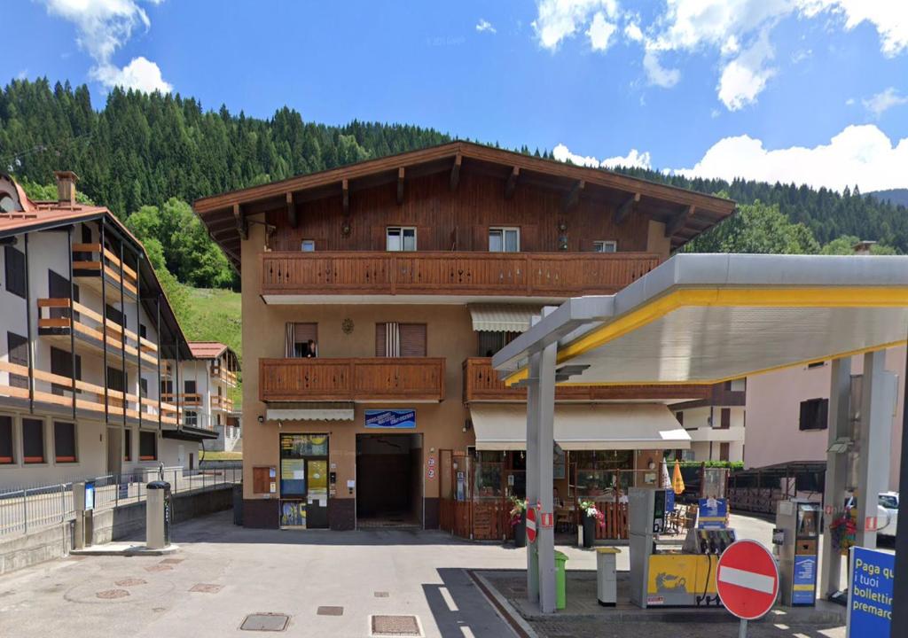 a building with a gas station in front of it at Pinzolo DOLOMIA apartment in Pinzolo