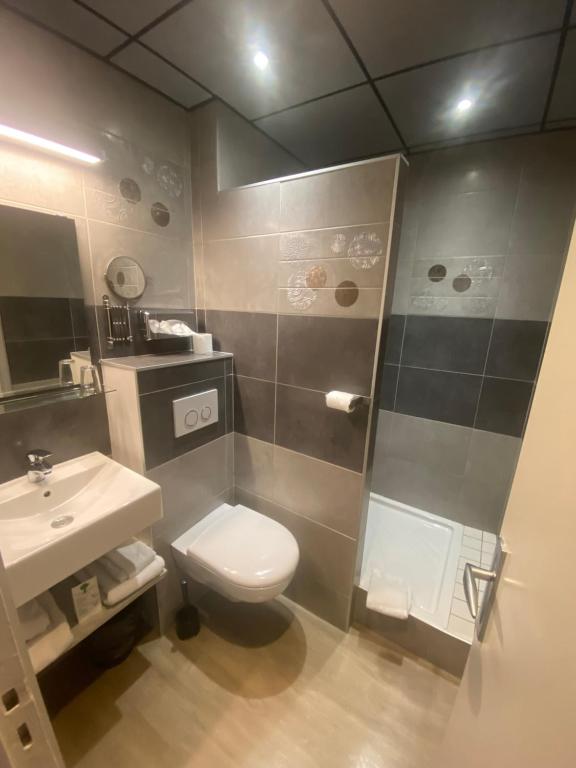 a bathroom with a toilet and a sink at Hotel Des Lices in Rennes