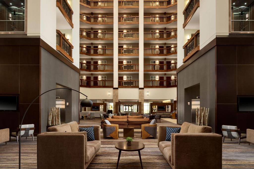 a lobby with couches and a large building at Minneapolis Marriott Northwest Hotel & Conference Center in Brooklyn Park