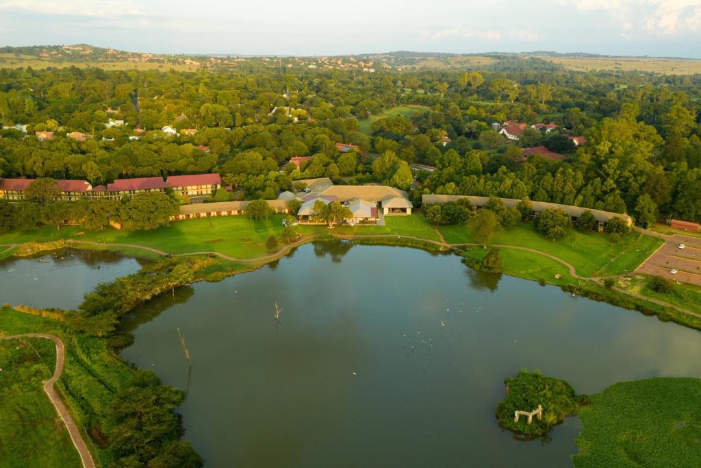 an aerial view of a house next to a lake at Irene Country Lodge, Autograph Collection in Centurion