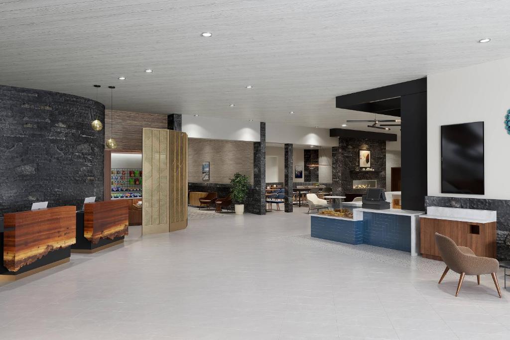 a lobby with a reception desk and a lobby at Delta Hotels by Marriott Grande Prairie Airport in Grande Prairie