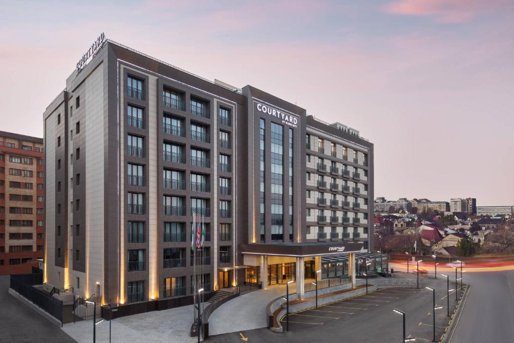 a rendering of a hotel building in a city at Courtyard by Marriott Tashkent in Tashkent