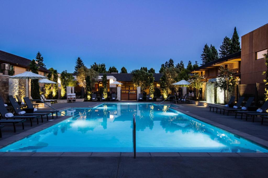 a large swimming pool at night with chairs and umbrellas at Napa Valley Marriott Hotel & Spa in Napa