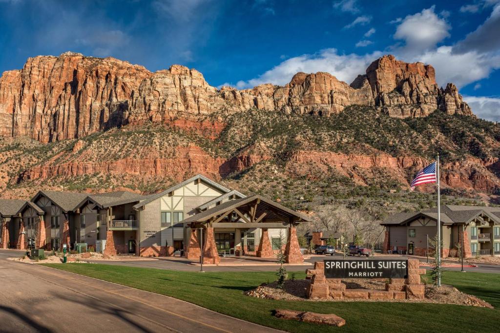 a hotel with a mountain in the background at SpringHill Suites by Marriott Springdale Zion National Park in Springdale