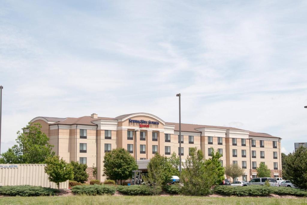 a large tan building with a sign on it at SpringHill Suites by Marriott Colorado Springs South in Colorado Springs