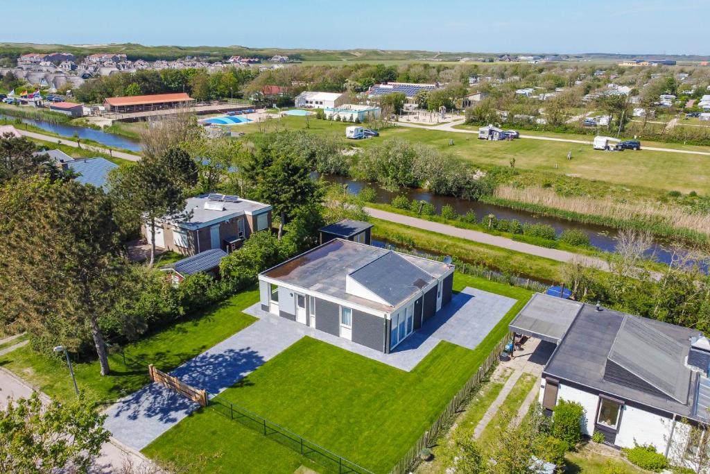 an aerial view of a house and a river at Familiehuis Noordenwind - Julianadorp aan Zee in Julianadorp
