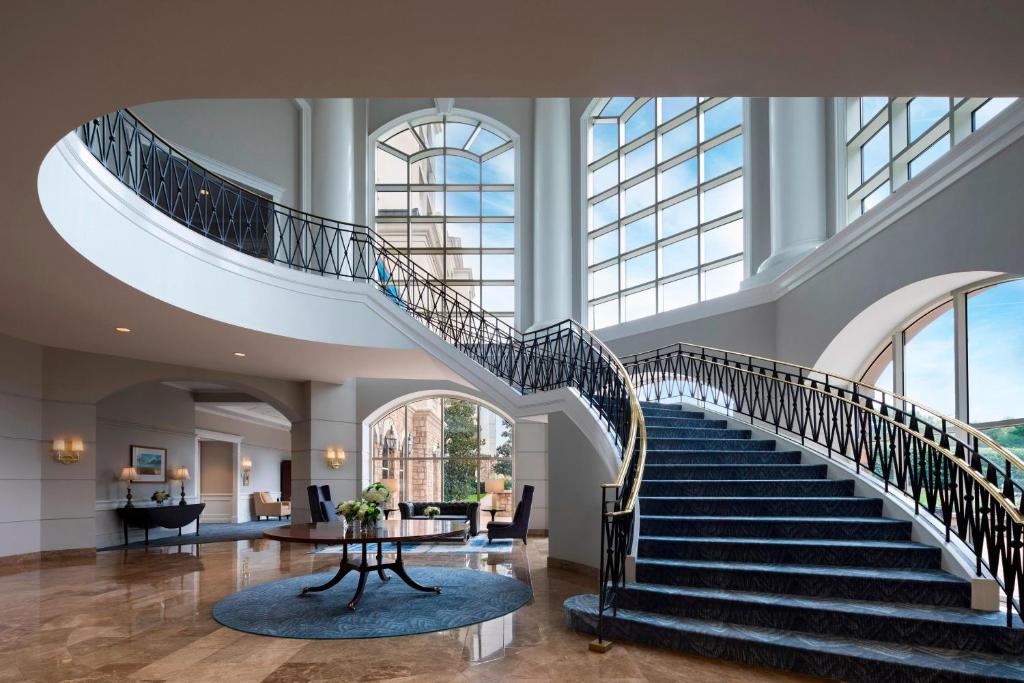 a spiral staircase in a building with a lobby at The Ballantyne, a Luxury Collection Hotel, Charlotte in Charlotte