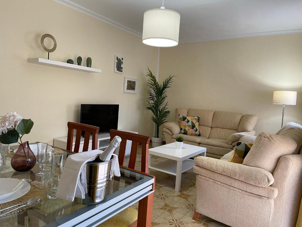 a living room with a couch and a table at Sea Life Salou Apartment in Salou