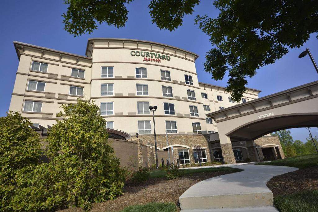 a large white building with a sign on it at Courtyard by Marriott Asheville Airport in Arden