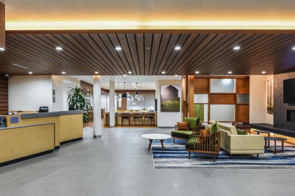 a lobby of a hotel with chairs and tables at Fairfield Inn & Suites Ontario Rancho Cucamonga in Rancho Cucamonga