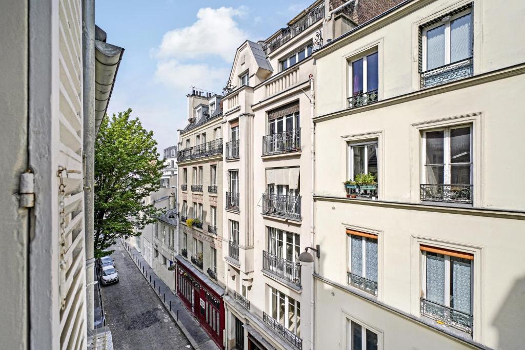 a street view of a building in paris at Home Sweet Home Paris Montmartre in Paris