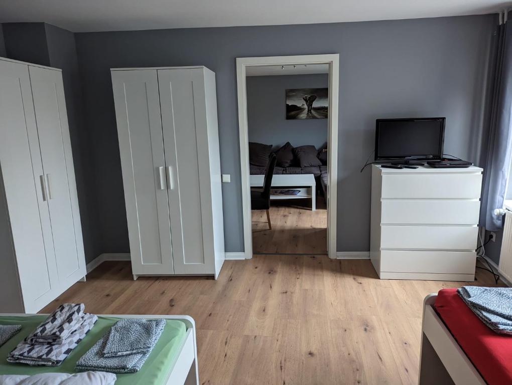 a living room with white cabinets and a television at Flensburg Zentrum 69 01 in Flensburg