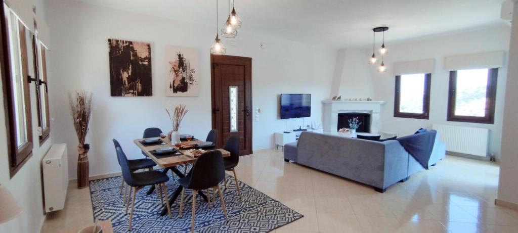 a living room with a table and a couch at "IRO HOUSE" 600m from the beach in Gerani