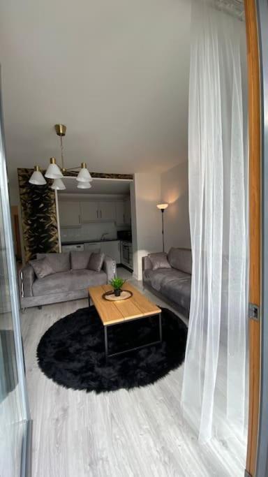 uma sala de estar com um sofá e uma mesa em Stunning Modern 2bed Apt Near Dublin City& Airport em Dublin