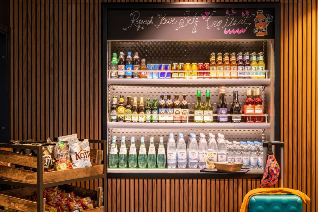 a refrigerator filled with lots of different types of drinks at Moxy Berlin Airport in Schönefeld