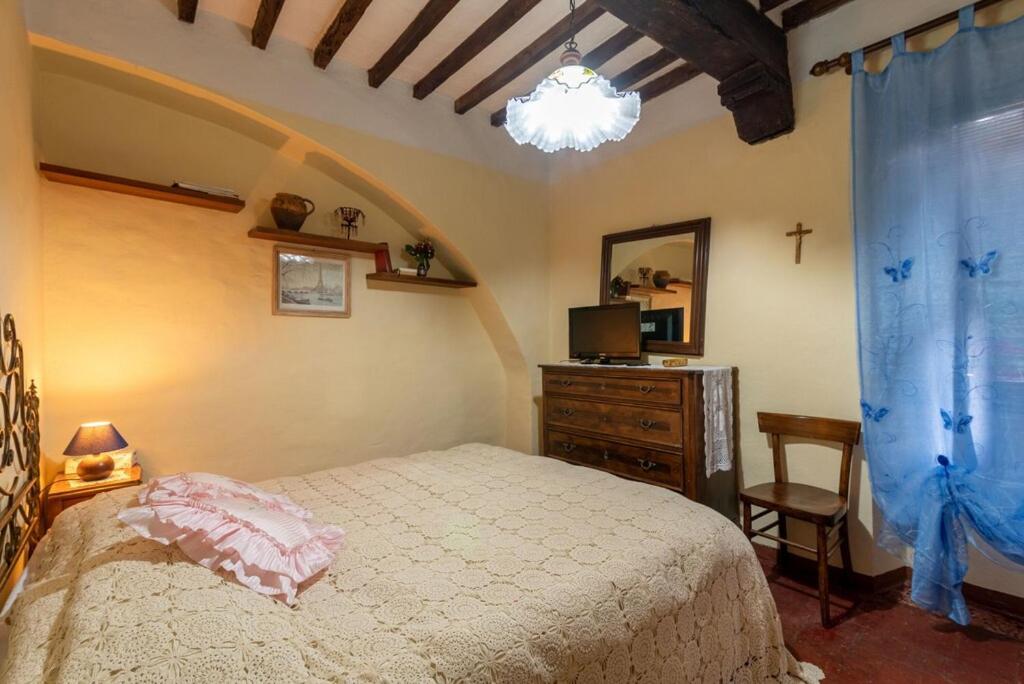 Postel nebo postele na pokoji v ubytování Casa Vacanza Lucignano
