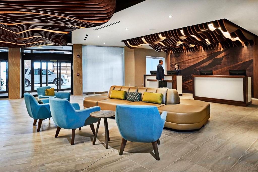 a lobby with a couch and blue chairs at Delta Hotels by Marriott Dartmouth in Halifax