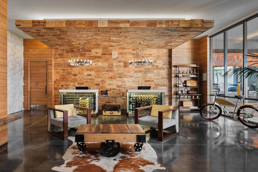 a lobby with a table and chairs and a brick wall at Epicurean Hotel, Autograph Collection in Tampa
