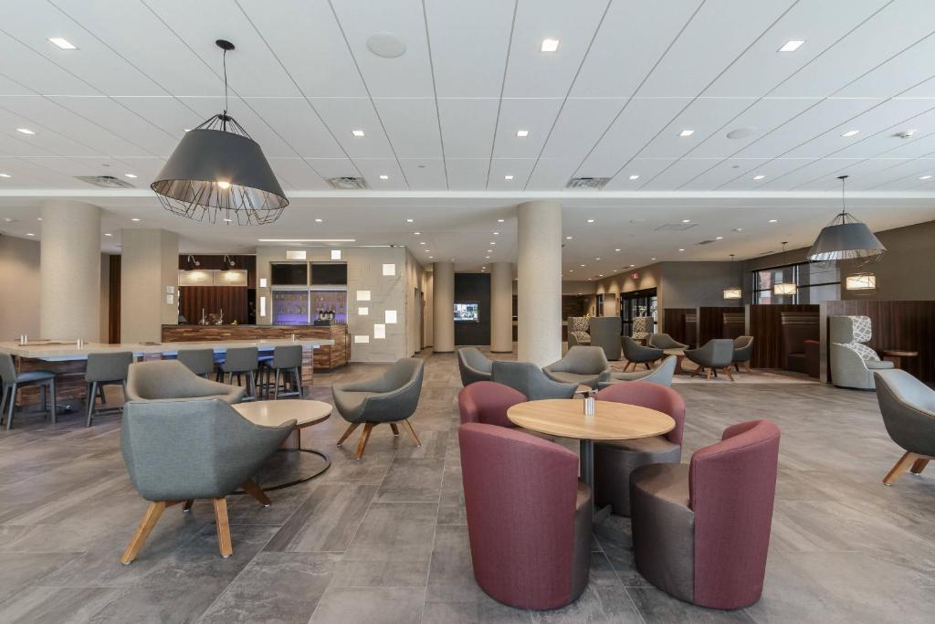 a lobby with tables and chairs and a bar at Courtyard by Marriott South Bend Downtown in South Bend