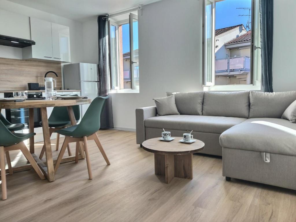 a living room with a couch and a table at Le Grand Evali - WIFI - Centre in Albi
