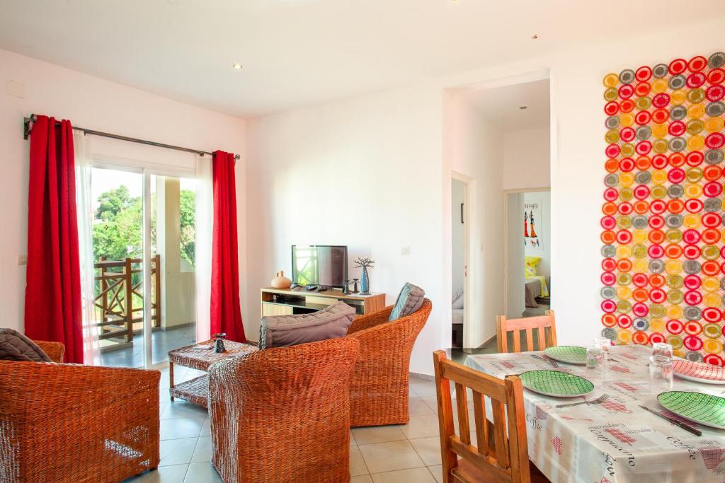 a living room with a table and chairs at LAMINA Appart in Antananarivo