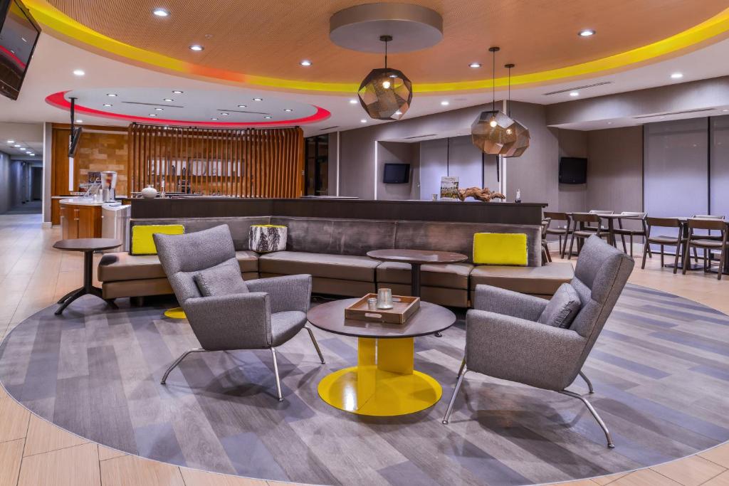 a lobby with a couch and chairs and a bar at SpringHill Suites Temecula Valley Wine Country in Temecula