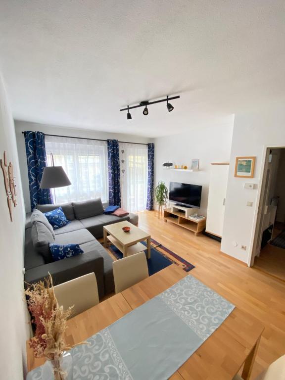 a living room with a couch and a table at cozy apartment close to vienna in Brunn am Gebirge