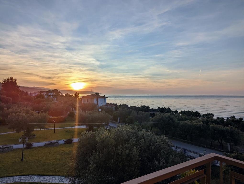 a view of the sunset from a balcony of a building at Lichnides Maisonette in Mola Kalyva