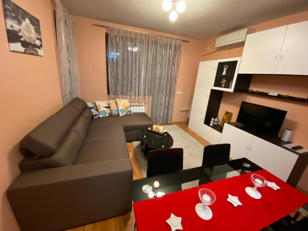 a living room with a couch and a red table at Mia's Apartment, Stylish One Bedroom Suite in Sofia