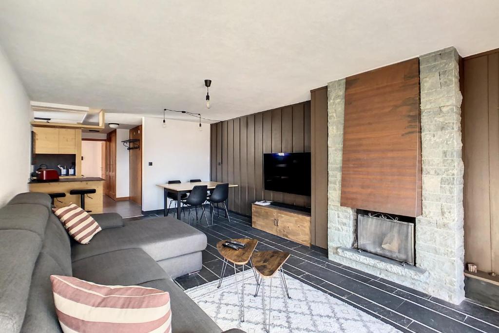 a living room with a couch and a fireplace at Ambassador 001 in Verbier