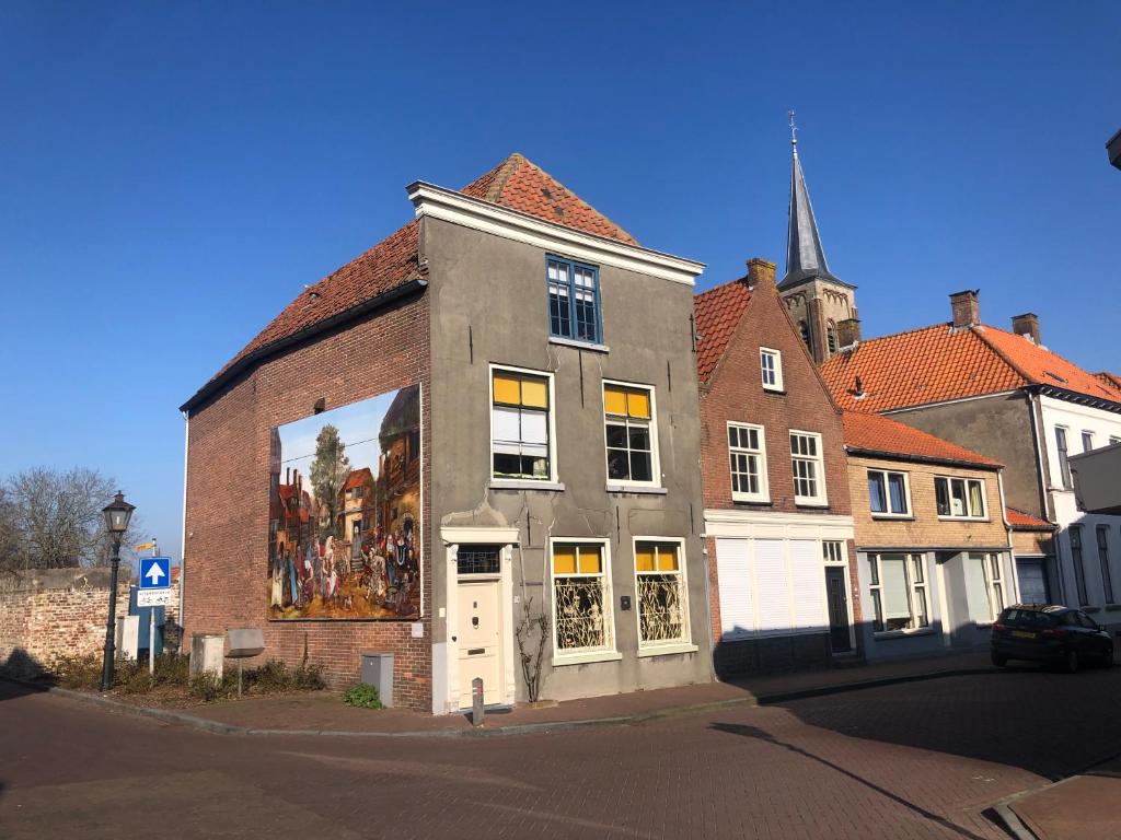 a building with a large mural on the side of it at Huis van Marietje in Aardenburg