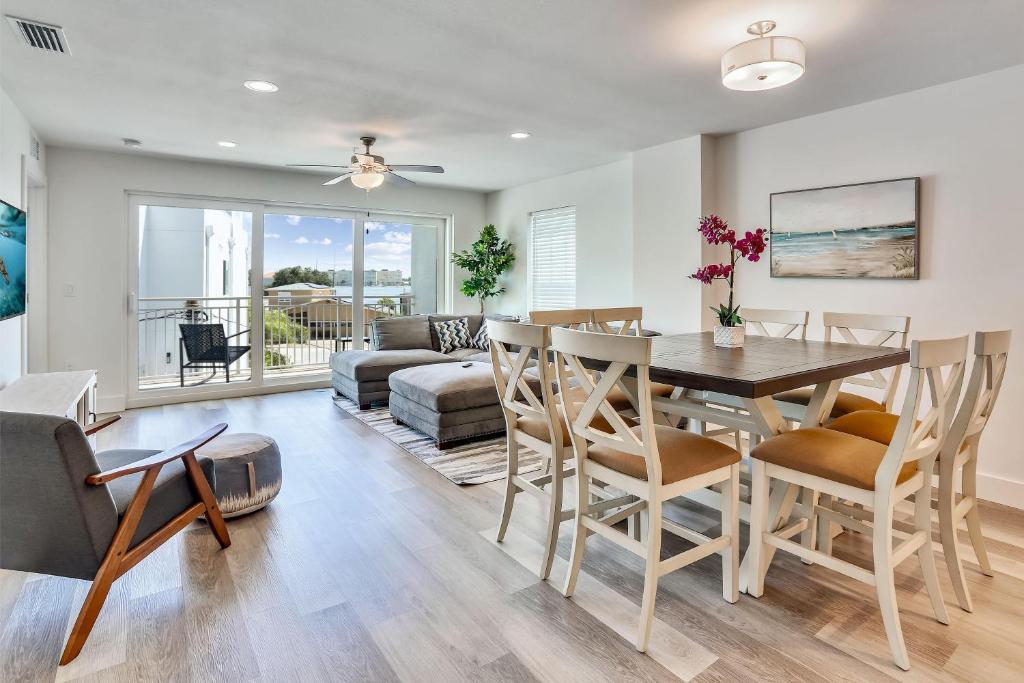 a dining room and living room with a table and chairs at Madeira Del Mar 305 in St. Pete Beach