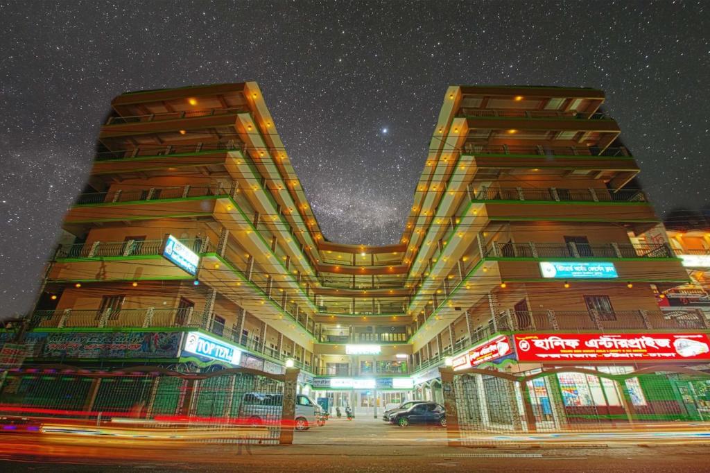 a tall building at night with a starry sky at Hotel Sea Queen in Cox's Bazar