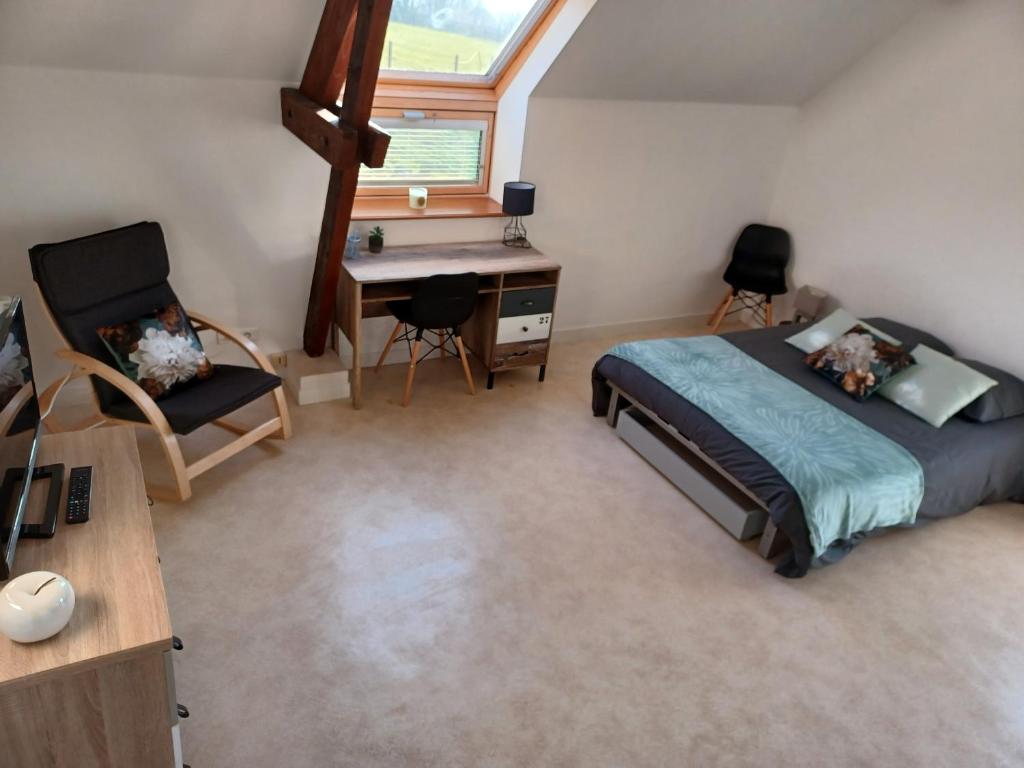 a bedroom with a bed and a desk and a desk at Joli Appartement avec vue sur la Baie in Avranches