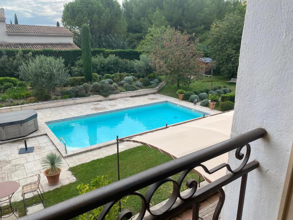 a view of a swimming pool from a balcony at Mas des IRIS in Saint-Rémy-de-Provence