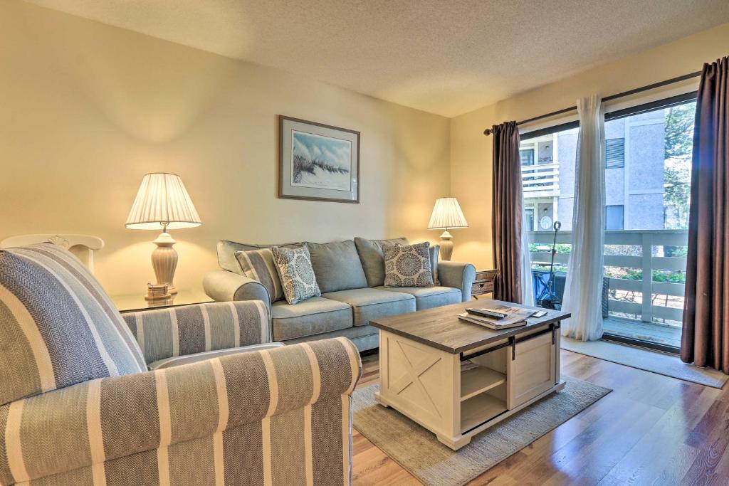a living room with a couch and a table at Walk to Beach Resort-Style Hilton Head Condo! in Hilton Head Island