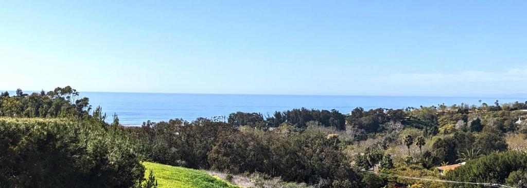 a view of a hill with the ocean in the background at The Heathercliff in Malibu