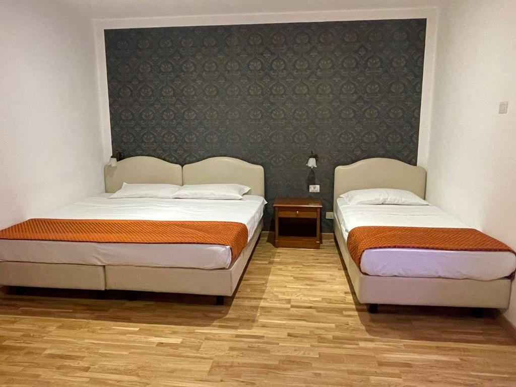 Postel nebo postele na pokoji v ubytování Hotel Fenicia