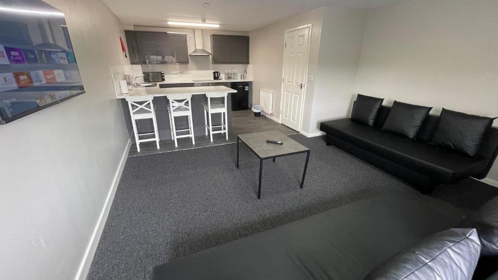 a living room with a couch and a table at Hosted By Ryan - 1 Bedroom Apartment in Liverpool