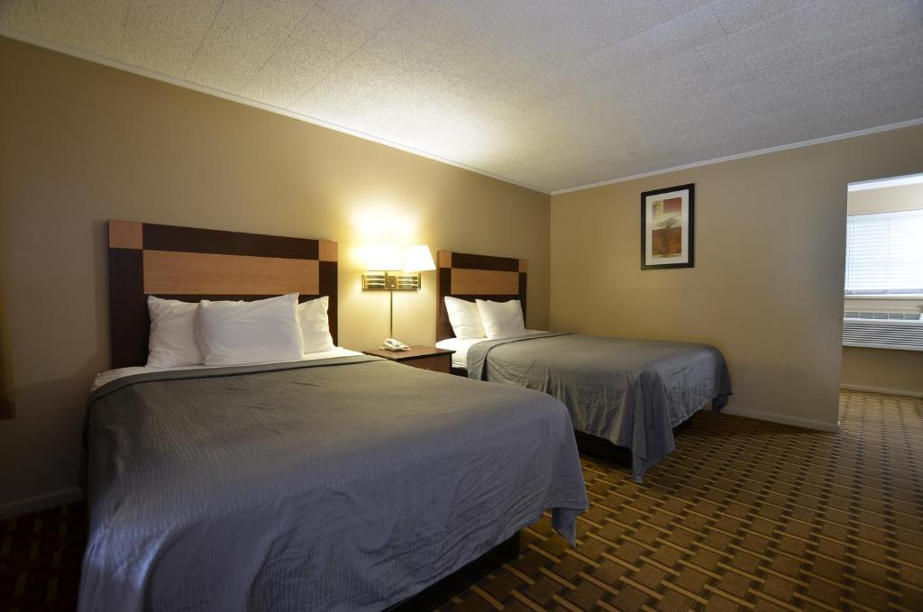 Habitación de hotel con 2 camas y ventana en Travelowes Motel - Maggie Valley, en Maggie Valley