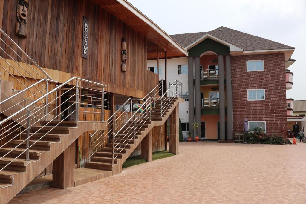 a building with stairs on the side of it at Golden Crystal Experience Hotel in Accra