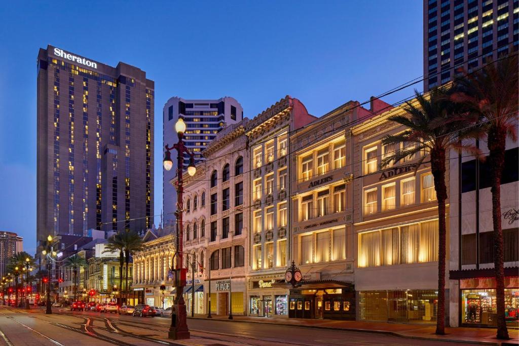 a city street at night with tall buildings at Sheraton New Orleans Hotel in New Orleans