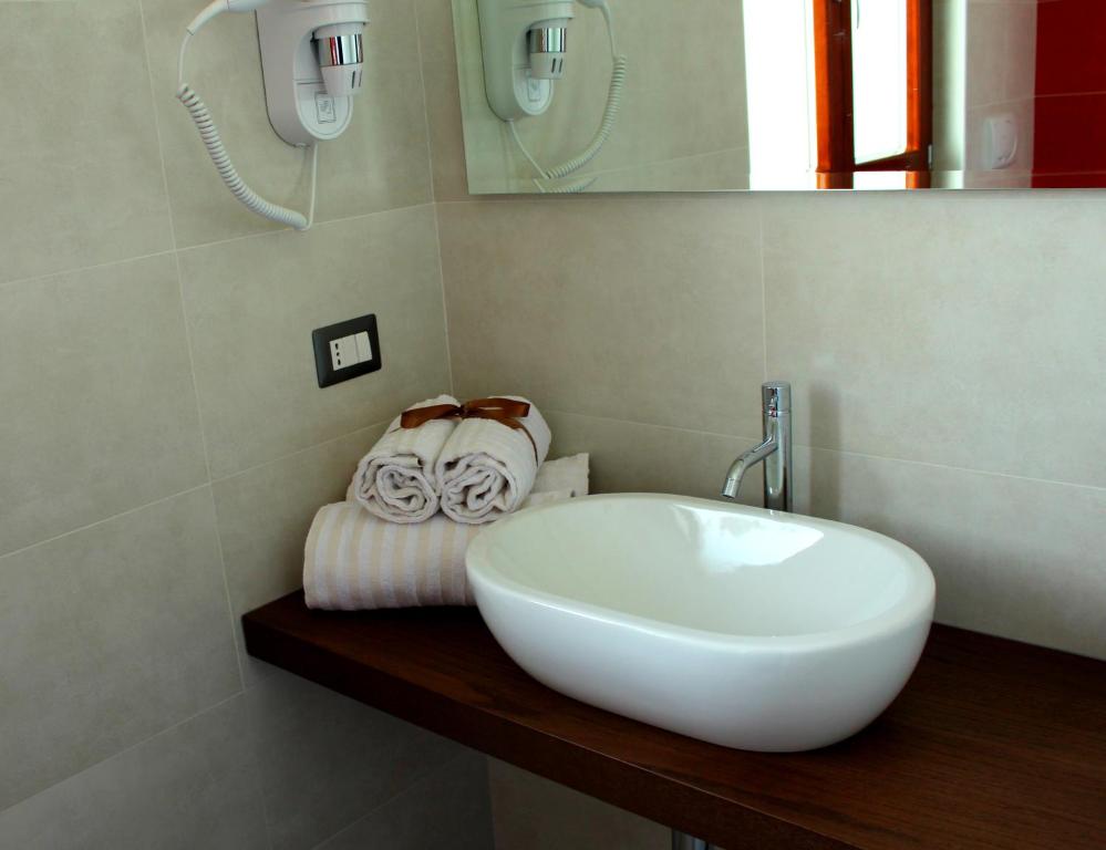 a bathroom with a sink and towels on a counter at Navicri B&B in Vieste