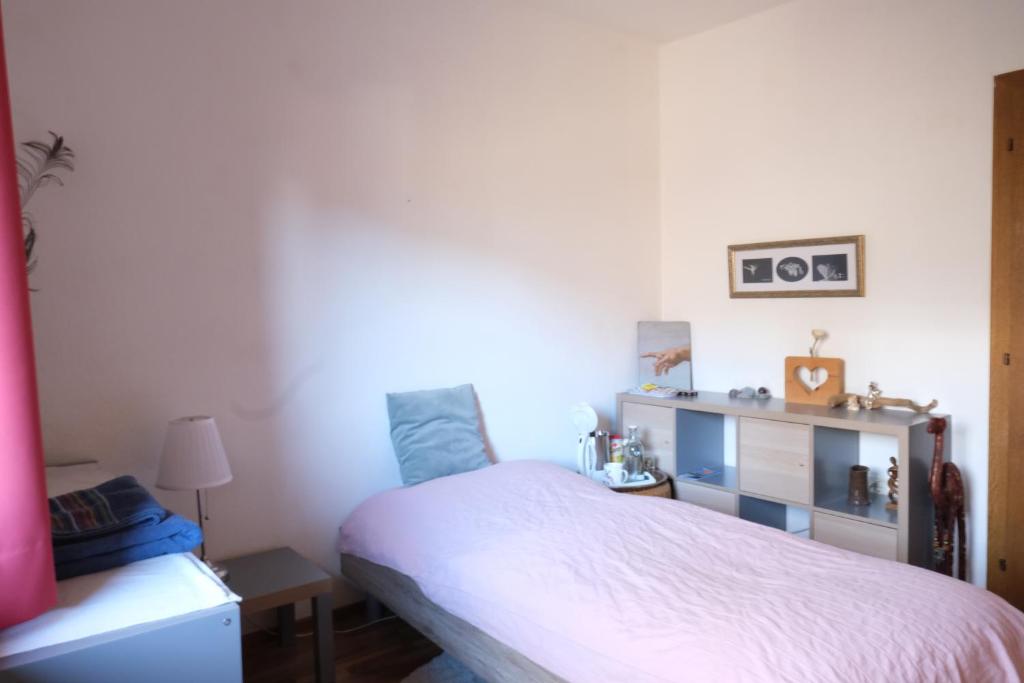 a bedroom with a white bed and a desk at Haus Blang Einzelzimmer in Innsbruck