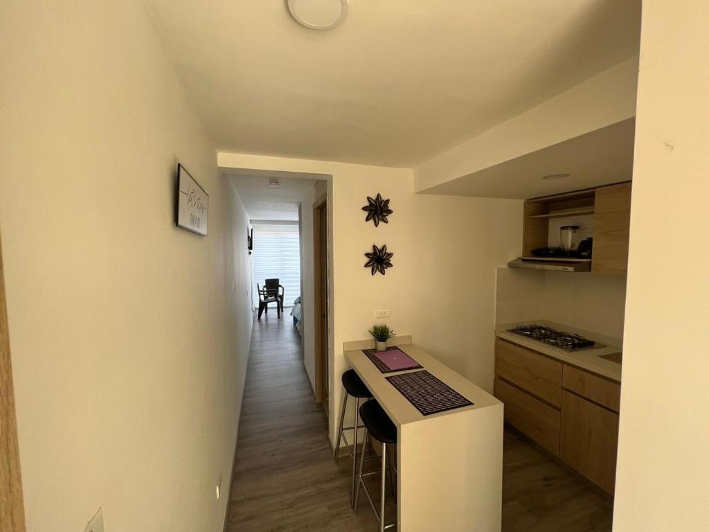 a small kitchen with a counter and a hallway at Apartamentos nuevos, comodos, amplios y moderno OK in Gaira