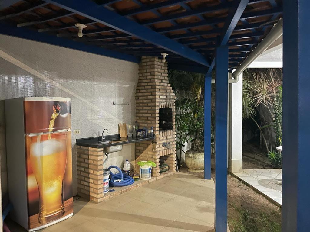 an outdoor kitchen with a refrigerator and a stove at CASA DA NINA in Tamandaré