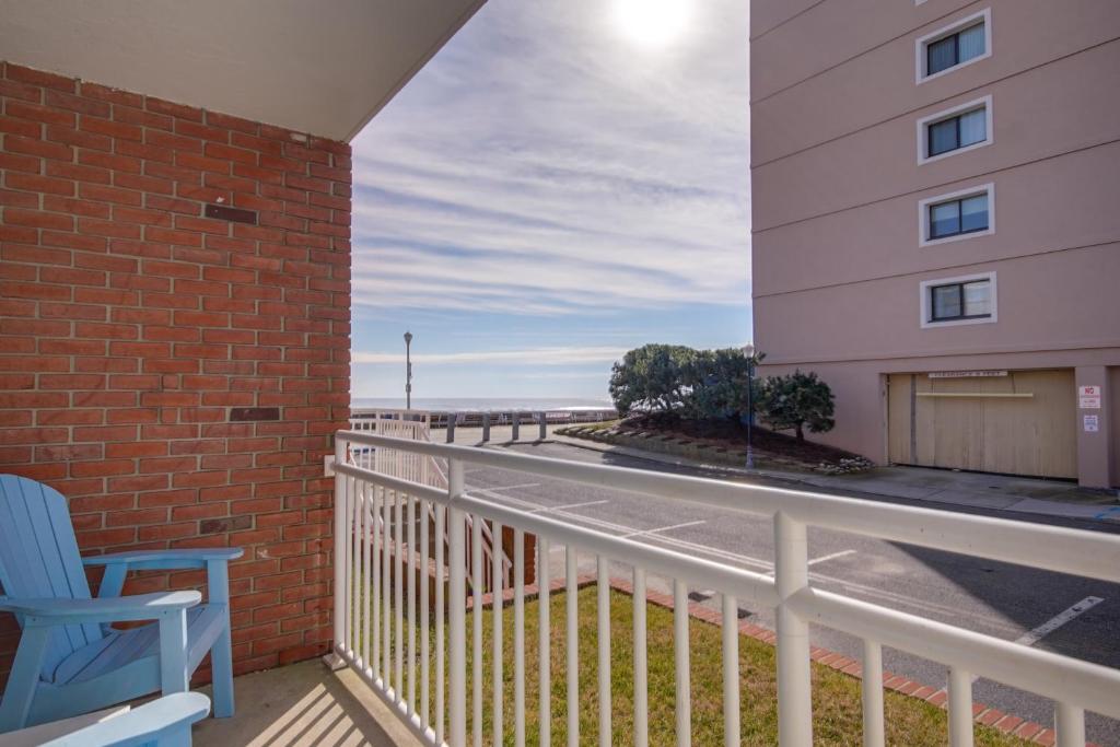 a balcony with a blue chair and a building at Sahara Motel in Ocean City